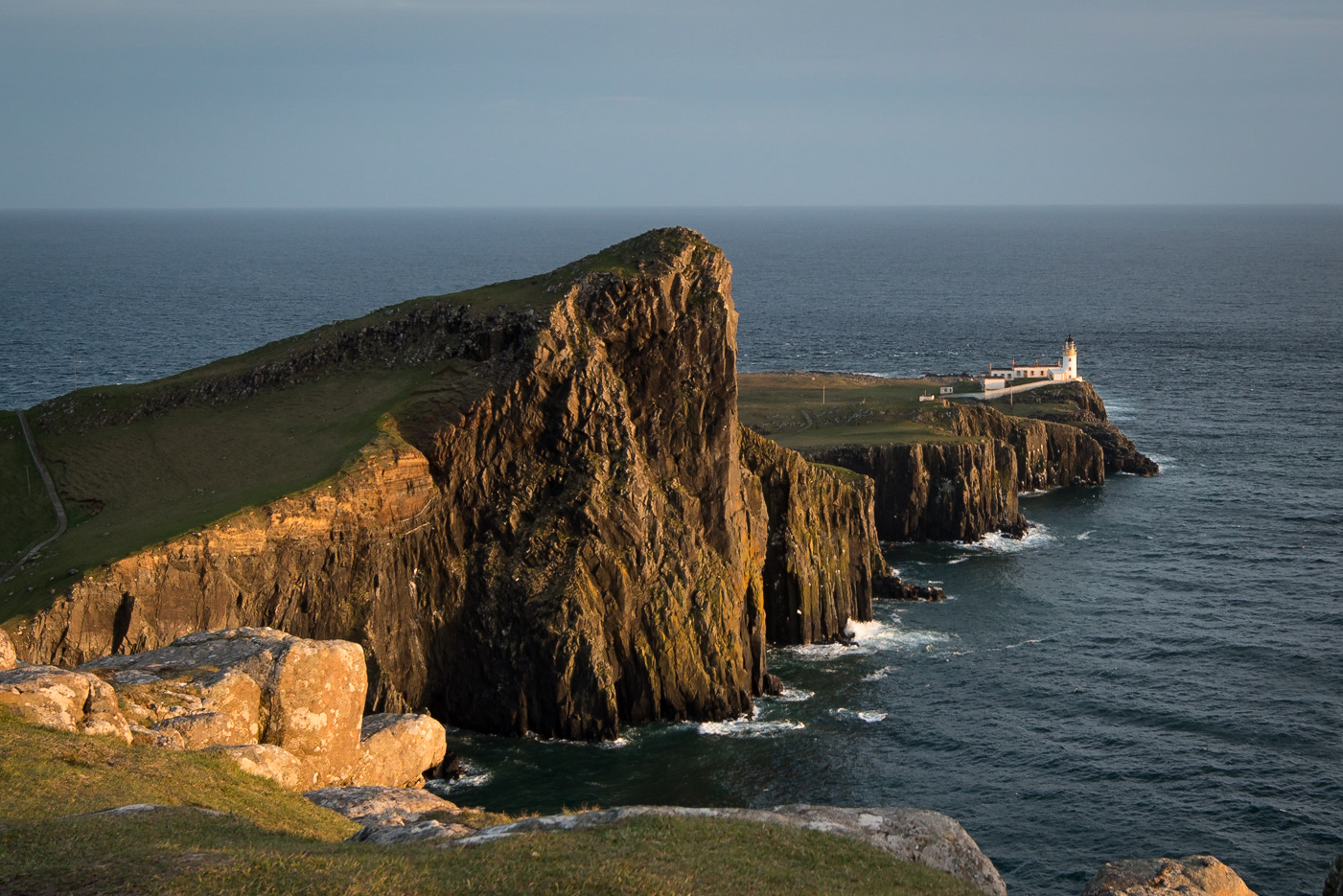 Neist Point on Skye at sunset, with the lighthouse in the distance