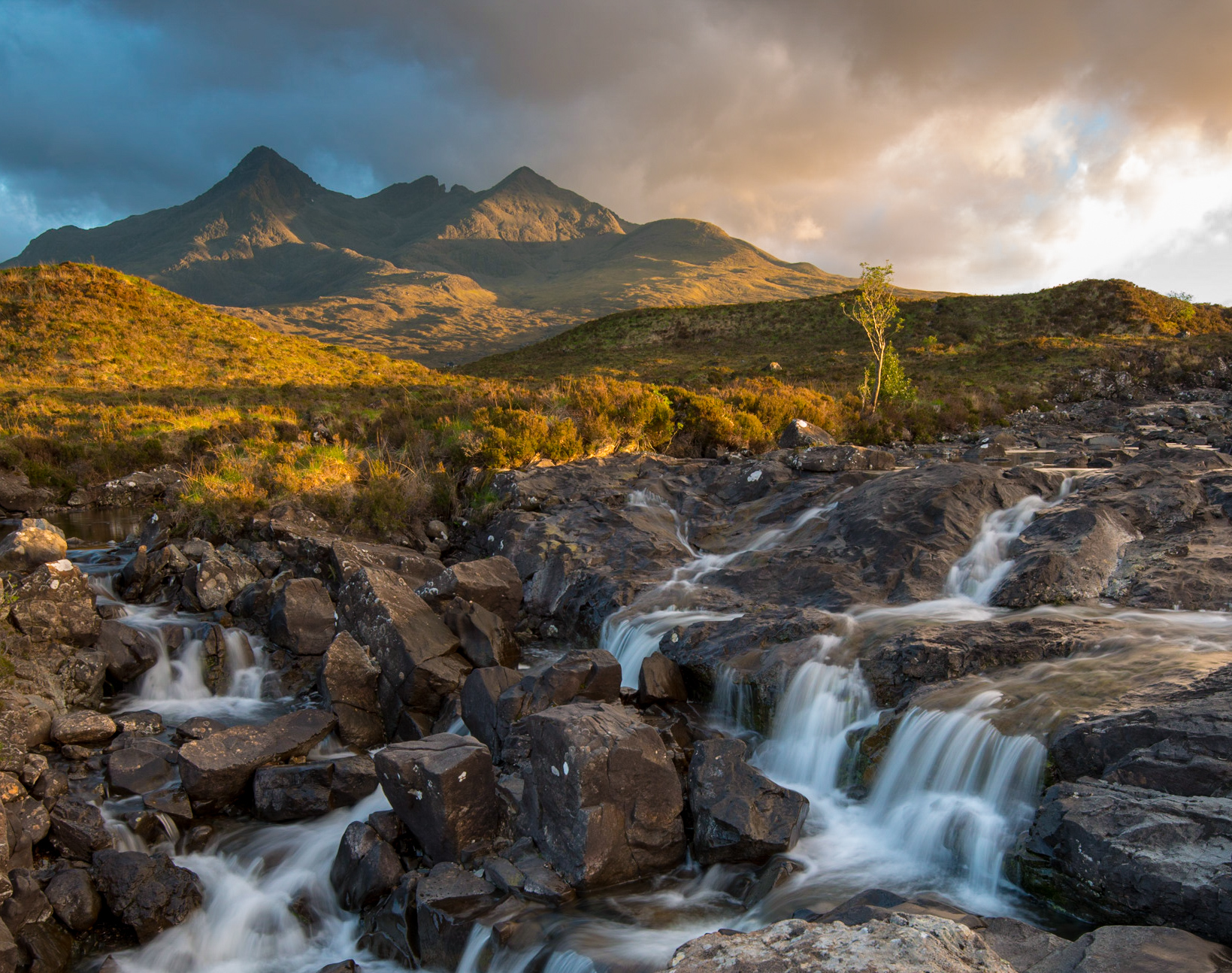 A view from Sligachan, Skye, Scotland. Showing mountains in the background, and small waterfalls in the foreground.